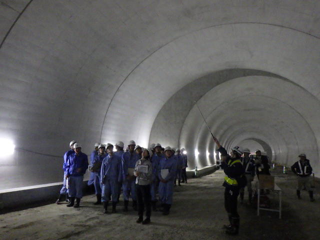 トンネル坑内で工事状況を見学する写真